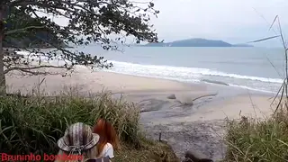 Two Voluptuous Latinas Share a Big Cock on a Public Beach