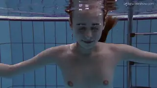Redhead Petite Babe Pisses Outdoors in Pool