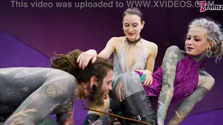 Tattooed Sub Takes a Pegging From Two Dominas