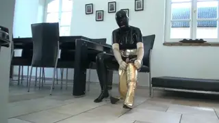 Busty Woman in Rubber Gear Pisses Into Golden Boots