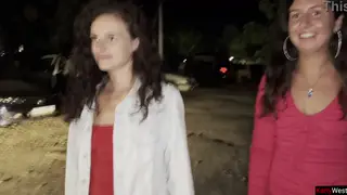 Teen Lesbians Piss Together Beside Car in Public Lot