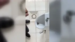 European Guy Strokes His Uncut Cock at a Public Urinal Until He Cums