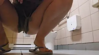 Petite Babe Lets Golden Stream Flow in Public Restroom