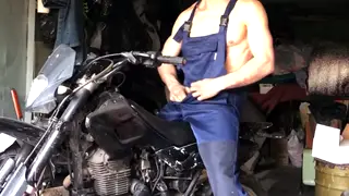 Mechanic Strokes His Cock Beside a Motorcycle