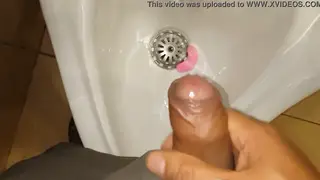 Solo Guy Strokes His Cock and Pisses at the Urinal