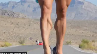Blonde Muscular Woman Flexes in Stockings Outdoors