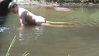 Solo Guy Strokes to Climax on River Stone