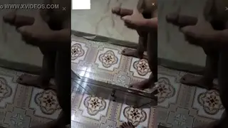 Asian Performer Strokes in Front of a Mirror