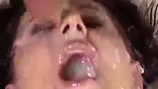 Brunette Drowns in Cum During a Wild Bukkake Gangbang