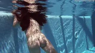 Brunette Swims Naked in a Sunlit Pool