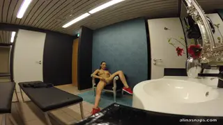 Brunette Teases Herself While Coach Watches in Public Bathroom