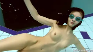 Teen Brunette Swims Nude in an Outdoor Pool
