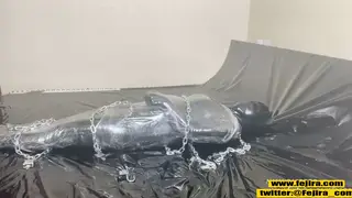 Japanese Woman Explores Bondage Pleasure in Tight Latex Wrap