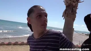 Busty MILFs Share a Cock in a Threesome on the Beach