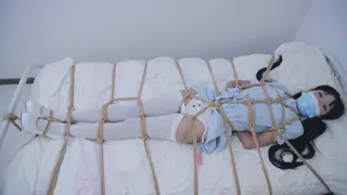 Asian Nurse in Stockings Dominates a Bound Patient with Toys