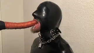 Latex Submissive Endures Machine Throat Penetration