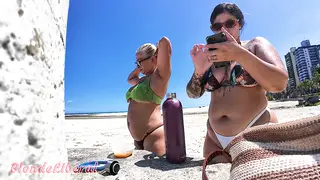 Blonde MILF Strolls the Beach in a Bikini With a Friend