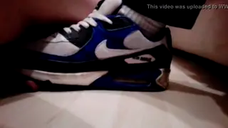 Guy Teases His Partner's Feet with a Tennis Ball